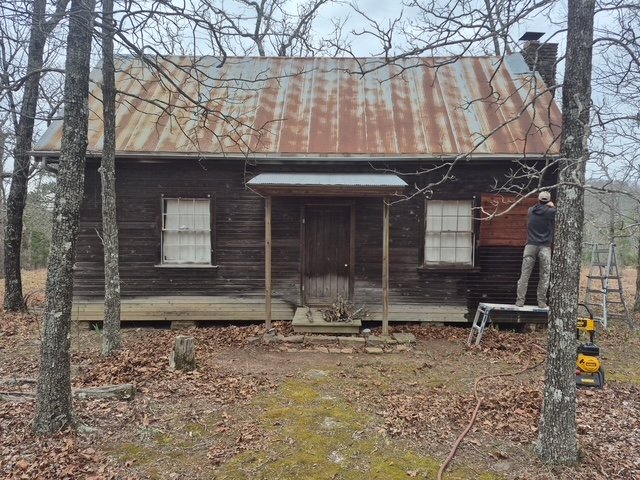 Cabin front, weathered and grey before restoration