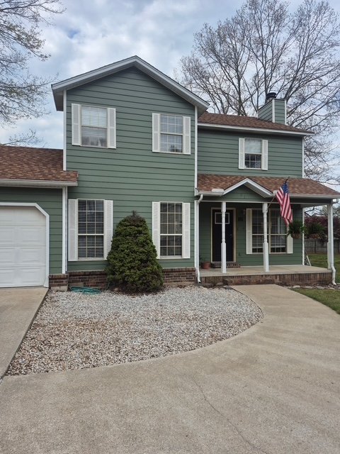 Two-story home with green exterior repaint