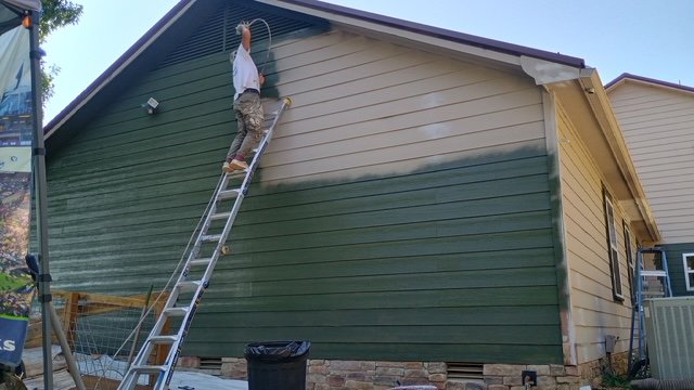 Repainting exterior siding from a ladder