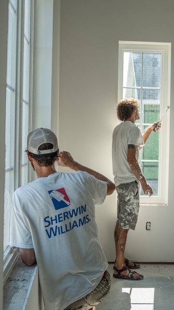 The two owners of Two Bros Paint Pros painting on the job